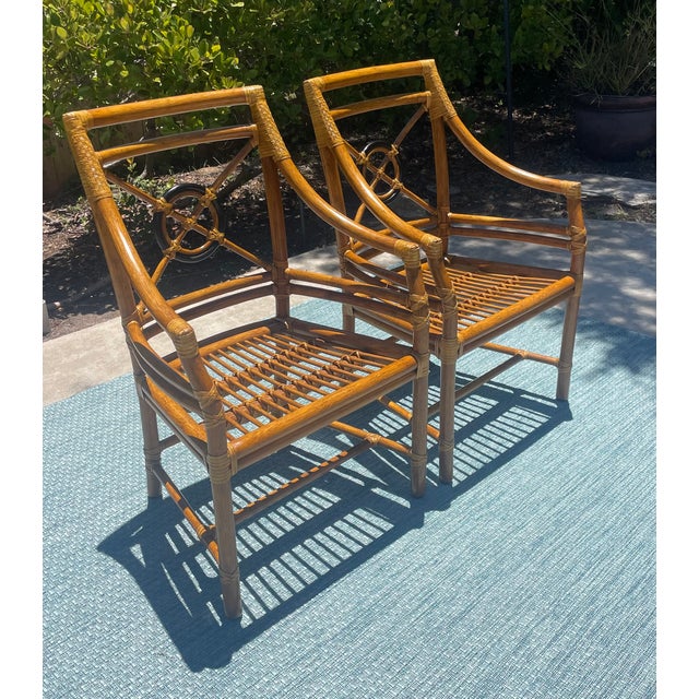 Classic pair of vintage rattan armchairs by luxury brand McGuire of San Francisco. They feature the iconic “Target Back”...