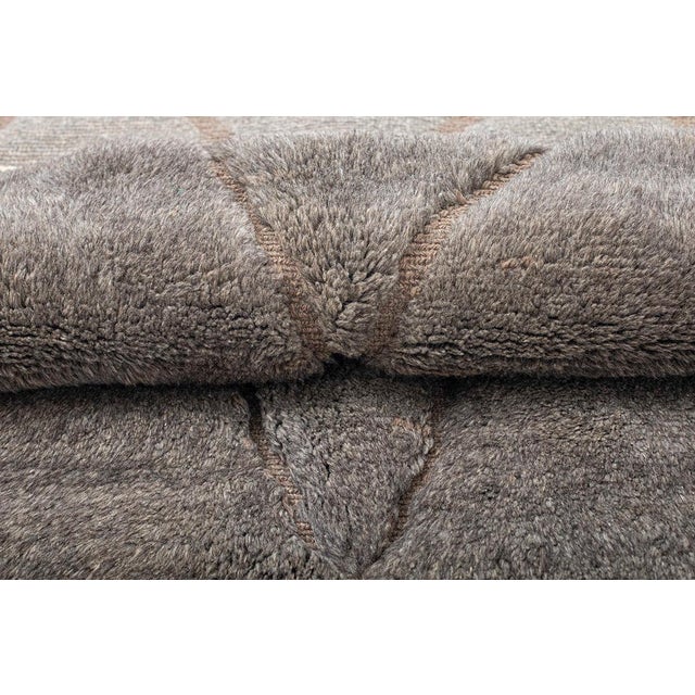 Luxurious hand-knotted wool rug in Cool Gray and Deep Taupe, adorned with a subtle abstract pattern. Its refined design...