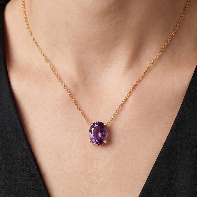 Celebrate timeless elegance with this exquisite Amethyst Solitaire Necklace, featuring a captivating 8 x 6 mm oval-cut...