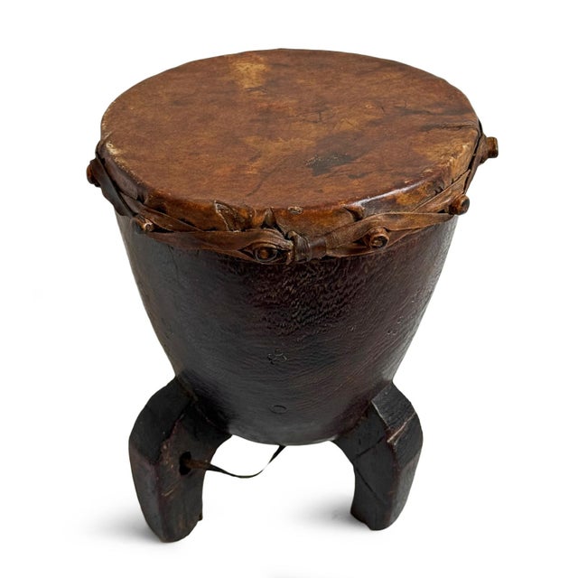 A rare late-19th-century Pygmy drum from featuring a beautifully timeworn hide drumhead, rich dark wood body, and...
