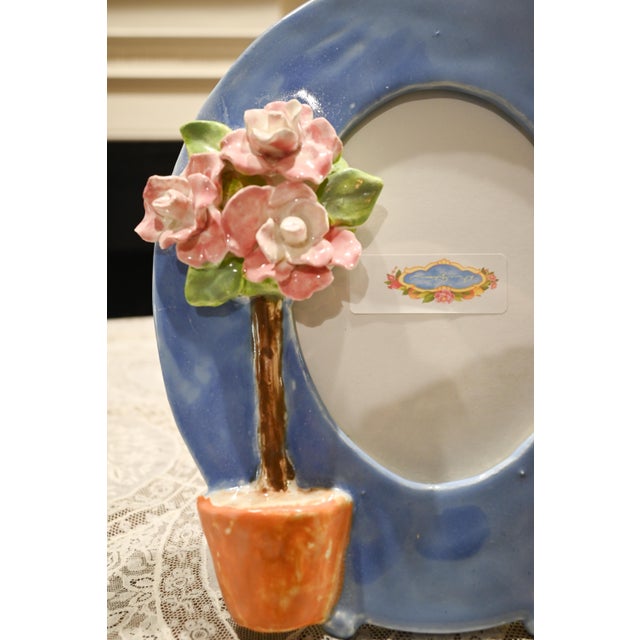 A special frame for a special someone. This Dana Gibson frame is a footed oval shape in a cerulean blue. To the side,...