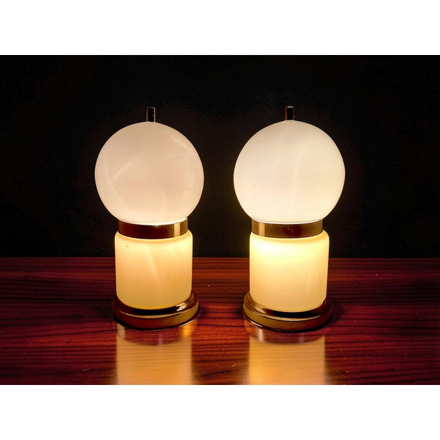 A pair of vintage table lamps in authentic Mid-Century Modern style, featuring a geometric design typical of the era. The...