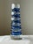 An octagonal Art Deco vase made of cut glass. A tall vase of layered blue and clear glass in the style of Carl Meltzer, of...