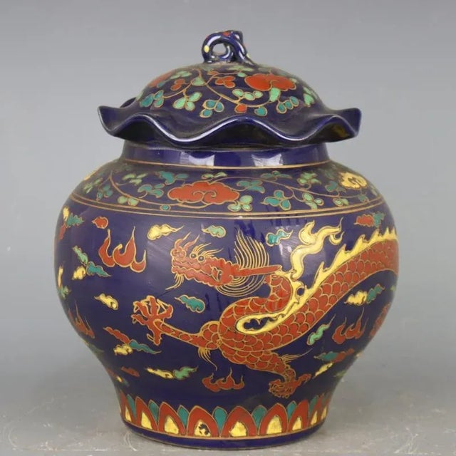 H-29.6cm,W-24cm The Blue Ground Famille Verte Porcelain Lid Jar is a hand-painted ceramic piece with a striking cloud...