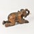 Beautiful vintage wooden elephant in kneeling posture with trunk positioned to hold a taper candle. Tusks are intact which...