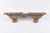 A pair of Italian richly carved giltwood wall brackets rom the second half of the 19th century with faux-marble painted...