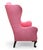 This 19th-Century wingback armchair is a classical seating piece upholstered in a richly toned rose-pink patterned fabric....