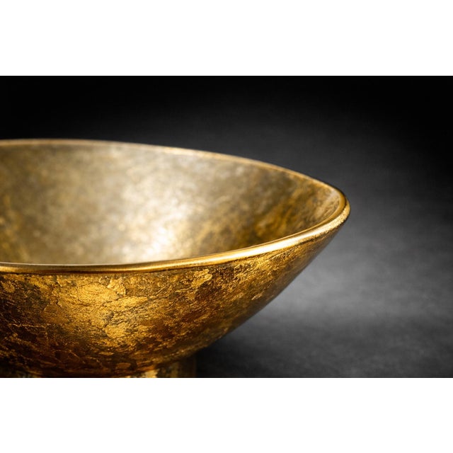 A striking vintage gold art glass pedestal bowl featuring a sculptural, shallow conical form and textured metallic finish....