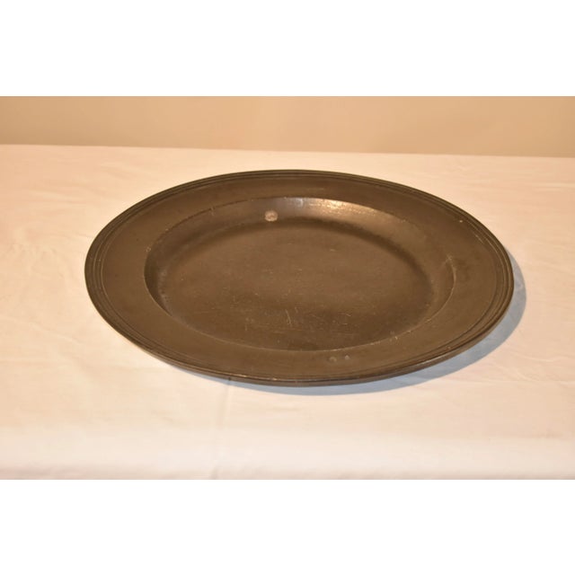 18th century large pewter charger with wide rim and molded edge, which is very elegant, especially for pewter, which was...