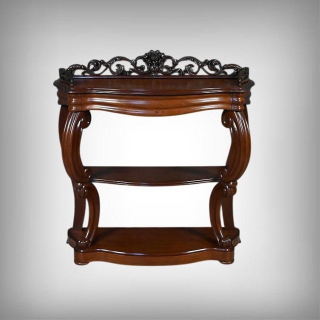 This superb napoleon iii period console in carved mahogany captivates with the elegance of its lines and the richness of...