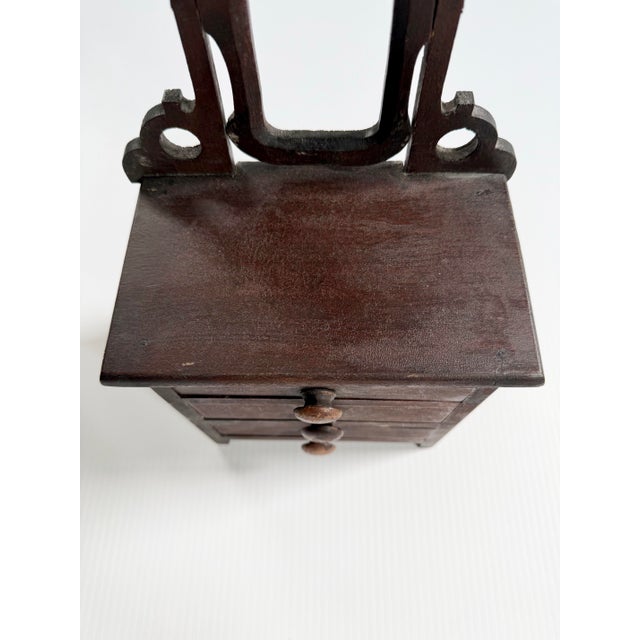 I believe this is a salesman’s sample dresser. Could be used as a piece of doll furniture or as a jewelry cabinet.