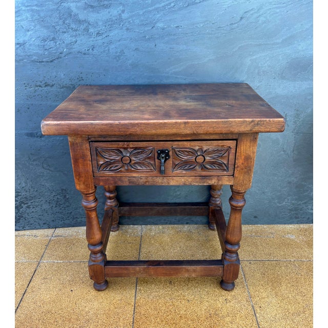 This charming pair of Spanish bedside tables dates from the mid-20th century and reflects the traditional rustic furniture...