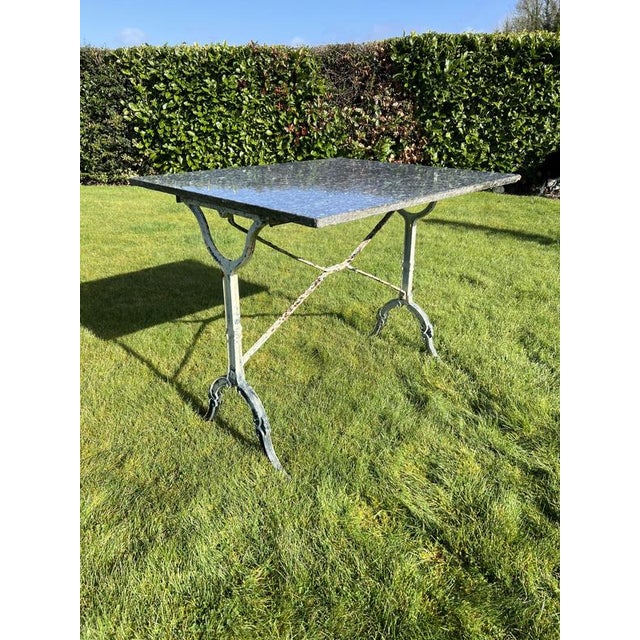A marble topped cast iron French bistro table