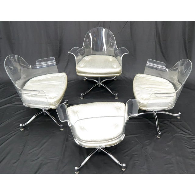 Mid-Century Modern set of 4 bent Lucite dining chairs. Silver patten leather upholstery. Chrome X-bases.