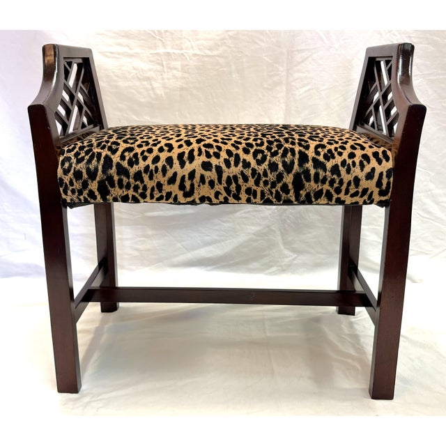 Classic vintage vanity stool from the mid 20th century. It is made of solid wood with curved arms perfect for tucking...