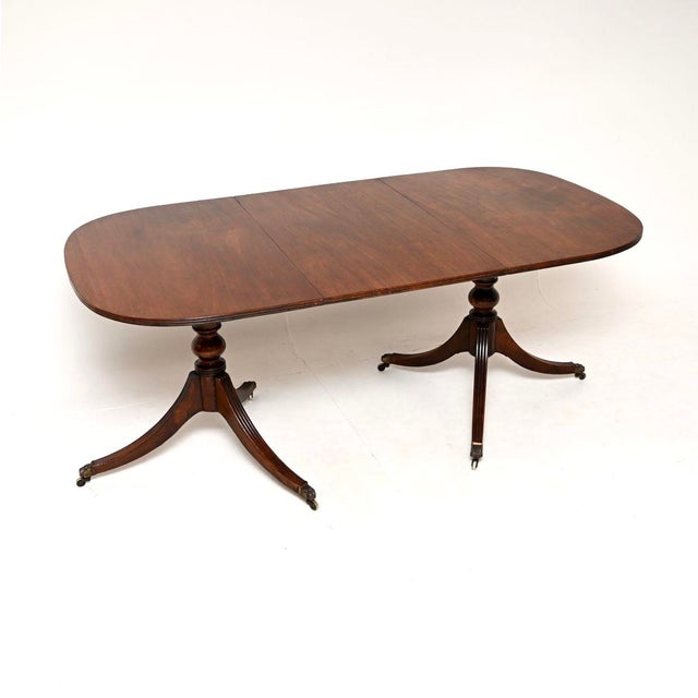 A large and impressive antique Regency style extending dining table. This was made in England, it dates from around the...