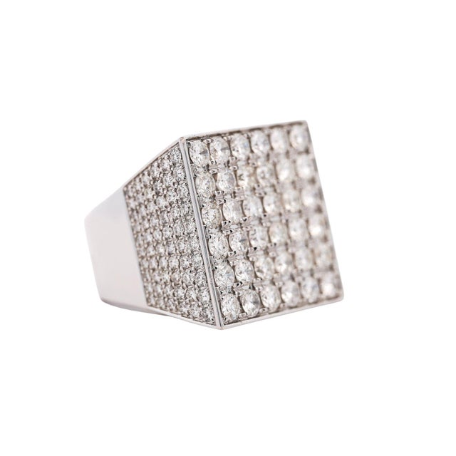 A fully diamond-paved square flat-top men's statement ring in 18K white gold, featuring 8.06 carats total weight of round...