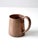 A vintage copper mug with a gently tapered form, rolled rim, and substantial riveted loop handle. The warm copper surface...