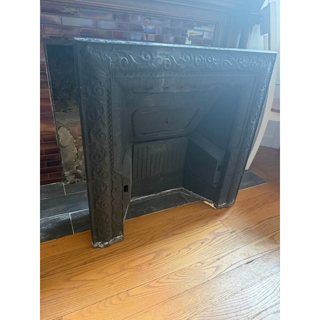 Beautiful original antique cast iron fireplace insert with intricate Victorian scrollwork and decorative detailing...