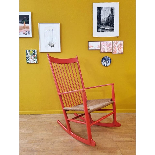 Rare rocking chair in beechwood, originally lacquered in orange-red. sturdy paper cord seat. designed by hans wegner for...