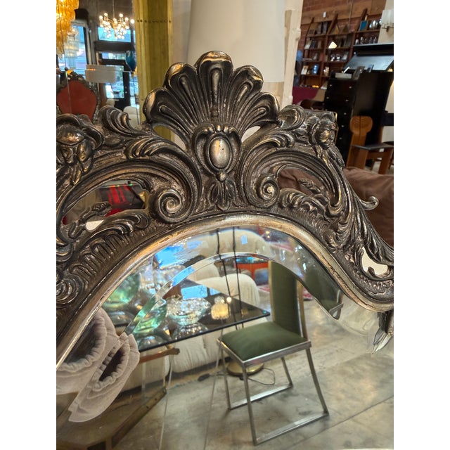 Elegant vintage tabletop mirror featuring an intricately detailed Baroque-style frame. The richly ornamented design...