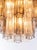 Elegant flush mount ceiling light with 24 clear and amber venini "tronchi" murano glasses on a golden brass frame....