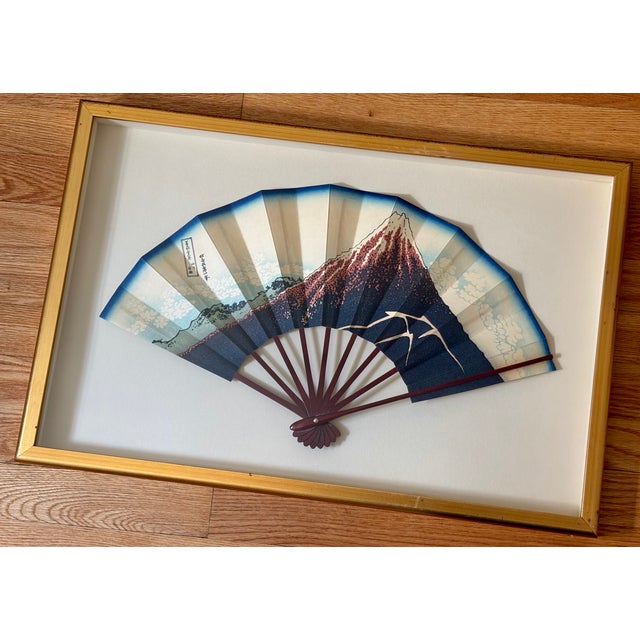 A decorative and rare 1960s Japonisme fan floating in a simple gold shadow box. Fan is a hand-painted reproduction after...