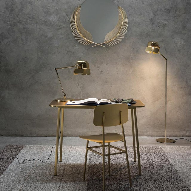This elegant floor lamp is shaped entirely of brass and features a round base supporting a stand with two-elements, the...