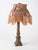 A beautiful vintage table lamp with an ornate neoclassical column base, softly aged bronze-toned finish, and an elaborate...