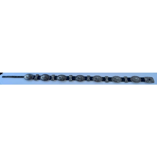 This fantastic belt has heavy hand-stamped silver conchos with scalloped edges; there are 13 alternating between butterfly...