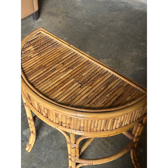 A wonderful small Demi-lune shaped console table. Executed in burnt bamboo with cane wrapping at the joints. This is a...