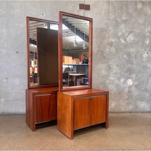 Pair of vintage Mid-Century Modern nightstands crafted in warm walnut with sleek chrome accents. Each features double-door...