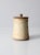 This vintage studio pottery jar features an earthy speckled tan glaze with etched detailing on one side and a small...