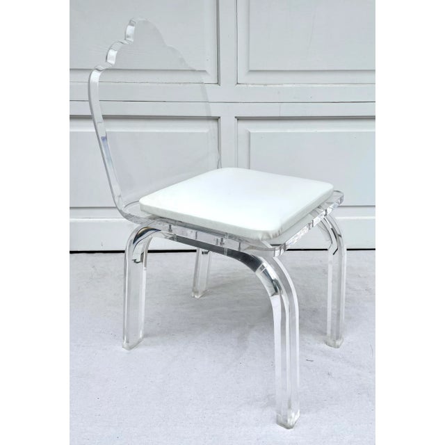 Here is a stunner of a chair that is made of thick, glamorous, transparent lucite! The chair features curved legs with...