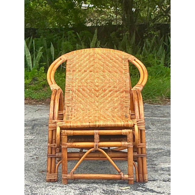Embrace relaxed elegance with this exquisite vintage rattan lounge chair, a perfect fusion of coastal charm and bohemian...