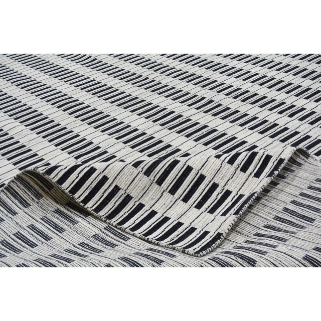 Hand-knotted with care using traditional rug-making techniques, this wool rug blends timeless craftsmanship with a modern...