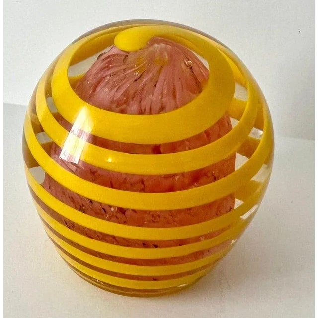 A unique and vibrant Art glass paperweight. This piece is a wonderful addition to any space, desk or shelf... the modern...