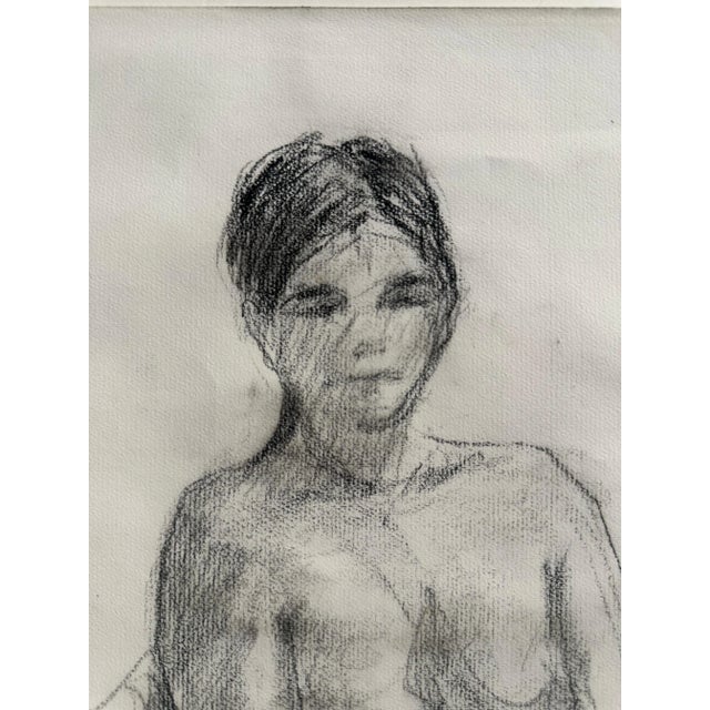 A woman seated with hands folded in lap. Drawn in charcoal.