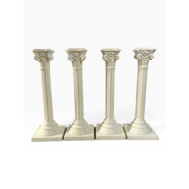 A set of four matching creamware corinthian column candle sticks from the late George III period, with marks to base...