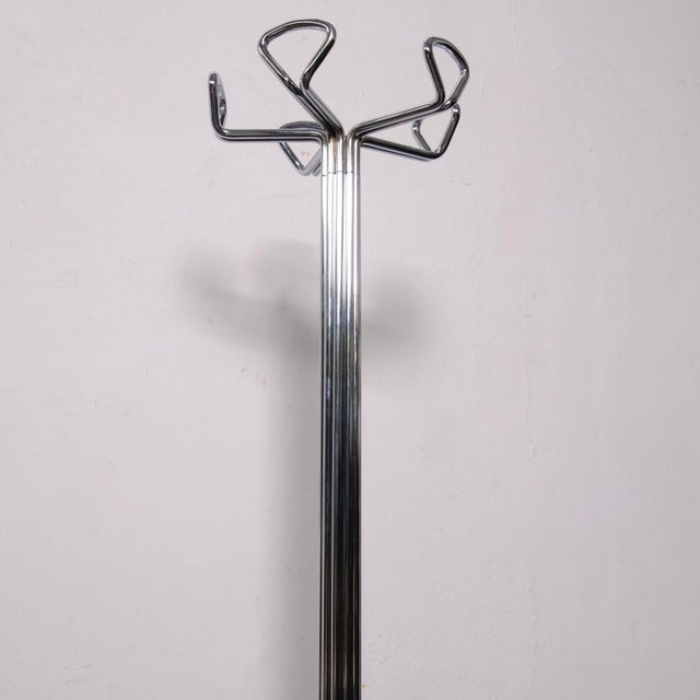 This is a vintage chromed metal coat rack from the 1970s, featuring a distinctive vertical tubular structure and a...