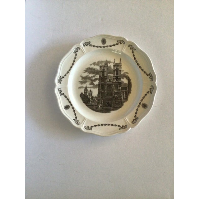 Made in England. 10-1/4” diameter. Ruffle rimmed cream background plates with historic buildings done in shades of gray...