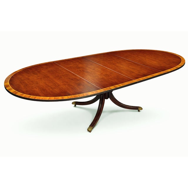 This Early Regency Revival Oval Dining Table is a beautiful dining furnishing with two leaves, elegant classical detailing...