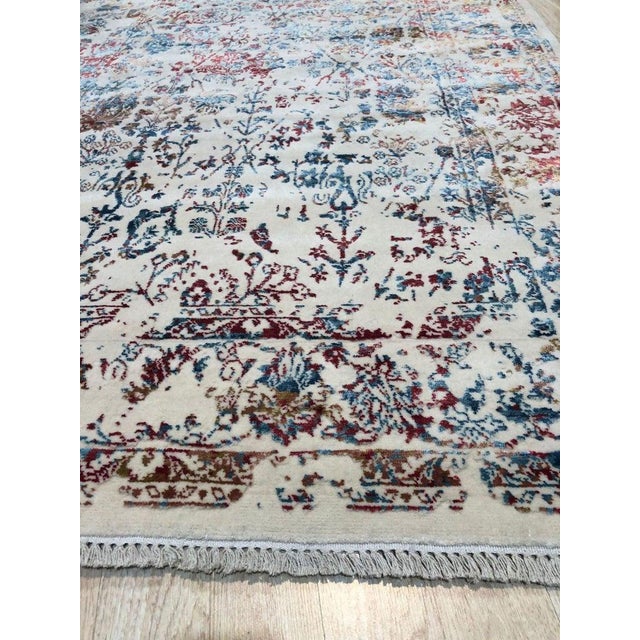 This machine made area rug features a primary color palette of ivory, beige, cream, and white. Crafted in India, the...