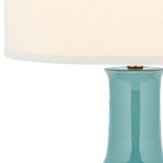 The Lamp is sure to illuminate any room with elegance and style. it's classic gourd body of medium sky blue glazed ceramic...