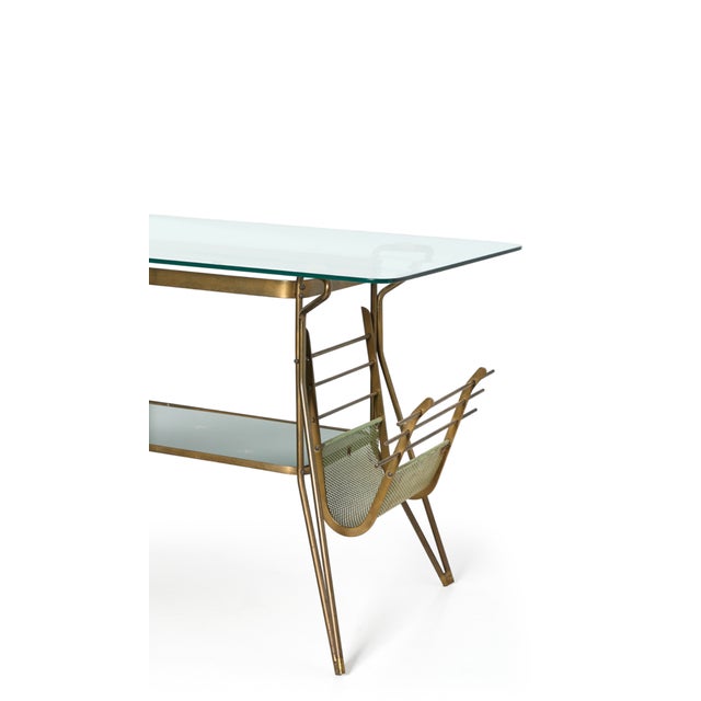 Vintage 1950s Italian coffee table attributed to Cesare Lacca, featuring a brass frame with with two glass shelves; the...