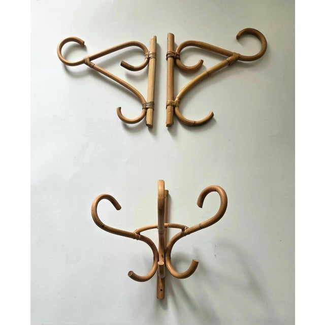 Offered is a set of 3 vintage bamboo rattan wall-mounted coat and hat racks (resembling Italian or French designer pieces...
