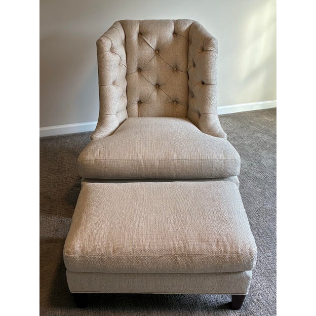 Elegant Baker Furniture lounge chair with matching ottoman featuring a dramatic tufted wingback silhouette and luxurious...