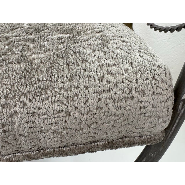 This is a hand forged wrought iron and brass newly upholstered bench. This bench features a hand wrought iron frame with a...