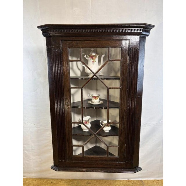 A beautiful antique georgian hanging corner cabinet dating from around 1830, full of charm, character, and timeless...