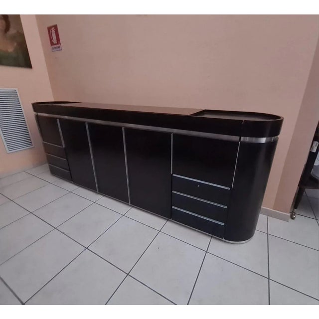 Wooden and steel sideboard from the 80s Special sideboard with curved sides, ideal for both wall and center. Dark wood...